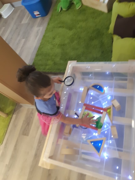 Child exploring the light table